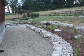 We used a combination of rock and pine bark much here to add contrast to the back wall landscape